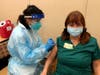 Brenda Jacobsen, M.Ed.,  Therapeutic Recreation Leader at the Waveny Care Center receives her vaccination. 