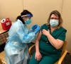 Rachel Hepner, Director of Social Services, rolls up her sleeve for the COVID-19 vaccine. 