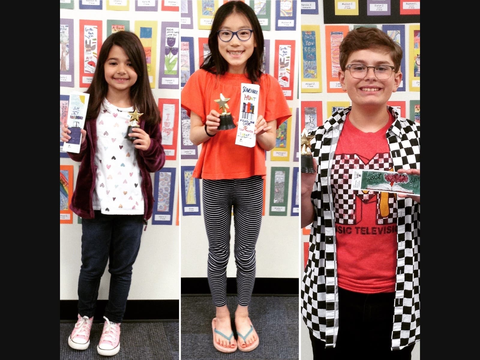 Winners of the 2019 Kids Bookmark Contest at Emma Clark Library holding up their winning entries.