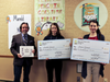 Library Director Ted Gutmann with 1st Place Winners (10 - 12th grade category) Anna and Amelia Grant receiving their big checks