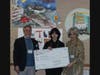 2023 winner Julia Hou (1st place winner in the 7 - 9th grade category) being presented with a big check by Library Director Ted Gutmann and Sherry Cleary, one of the daughters of the late Helen Stein Shack.