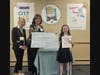 1st Place Winner Vivienne Rochlin-Hizver (Grades 6 - 8 category) receiving her big check from Emma Clark Library Director Theresa Liguori and Karen Shack Reid, daughter of the late Helen Stein Shack.
