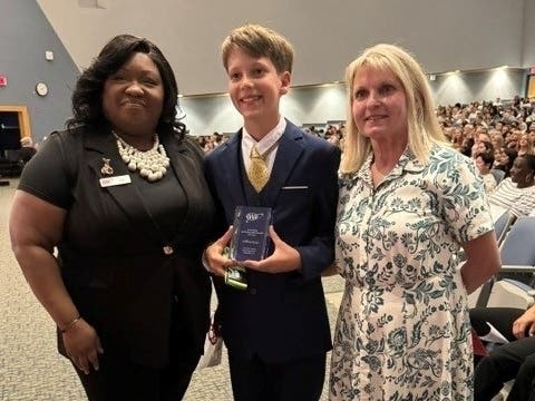 Pictured from left to right: Charon Hughes, AAA Assistant Retail Manager; William “Will” Kinne, AAA Outstanding School Safety Patroller; Debra Rozek, AAA Patrol Sponsor.

