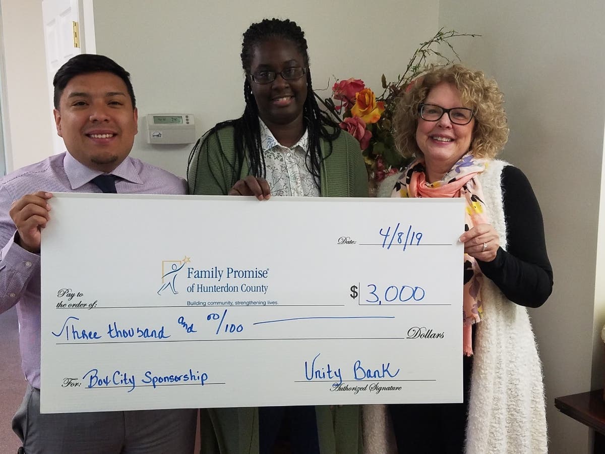 Angela Fields of Family Promise (center) with Unity Bank's Luis Moposita (left) and Corrine Reilly.