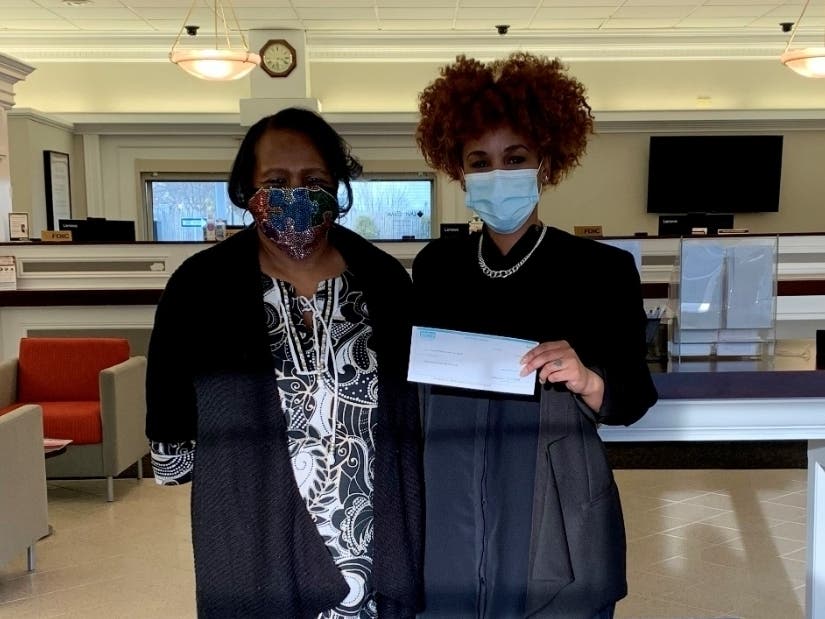 Taleana Williams-Hurst (left), Founder and President of WallynZavy’s Autistic Kids Can Do, receives a $2,500 donation from Paige Burwell, Unity Bank Area Manager.
