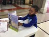 Kindergarten student examining Meyer's new book.