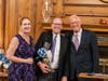 Terri Bowen joins with Chairman of the Board John Grube as they present a gift to James Parsons for his dedicated service to the K-B Board.