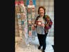 Rose Ann Hoof of Burr Ridge poses near the display of beautiful cards she created for the gift shop at King-Bruwaert House.