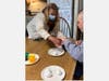 Trinity Services Independent Living Coach Jacque Anderson (left) helps James Hesson dye Easter eggs.
