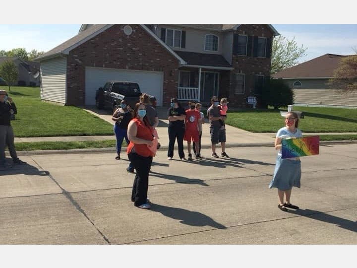 Friends, family and colleagues of Trinity Services Direct Support Professionals Michaela Atchie and Adam Arthur cheer them on after they end a 30-day shift at a group home in Mascoutah, Illinois.