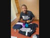 Josh, who receives support from Trinity’s Residential Network III, opens his gifts on Christmas morning at his home in Crete.