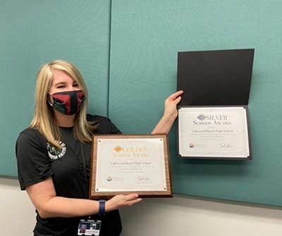 LRHS student services secretary Kari Keech-Babcock shows off the school’s awards.