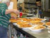 Ollie oversees the Talia Di Napoli pizza before serving