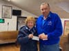 Larry Giordano, founder and president of the Foster Kids of Merrimack Valley, accepts a donation from Lodge member Carolyn. 