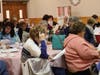 Members read along to "I am an Italian American"