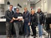 Members visit the new INspire Cafe location with a donation.