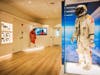 Display of space suits and headsets in new David Clark facility.