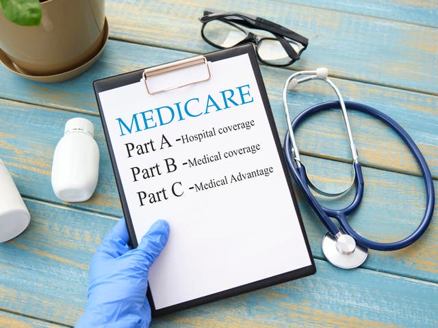 Stethoscope with medicare form with parts list in hand.