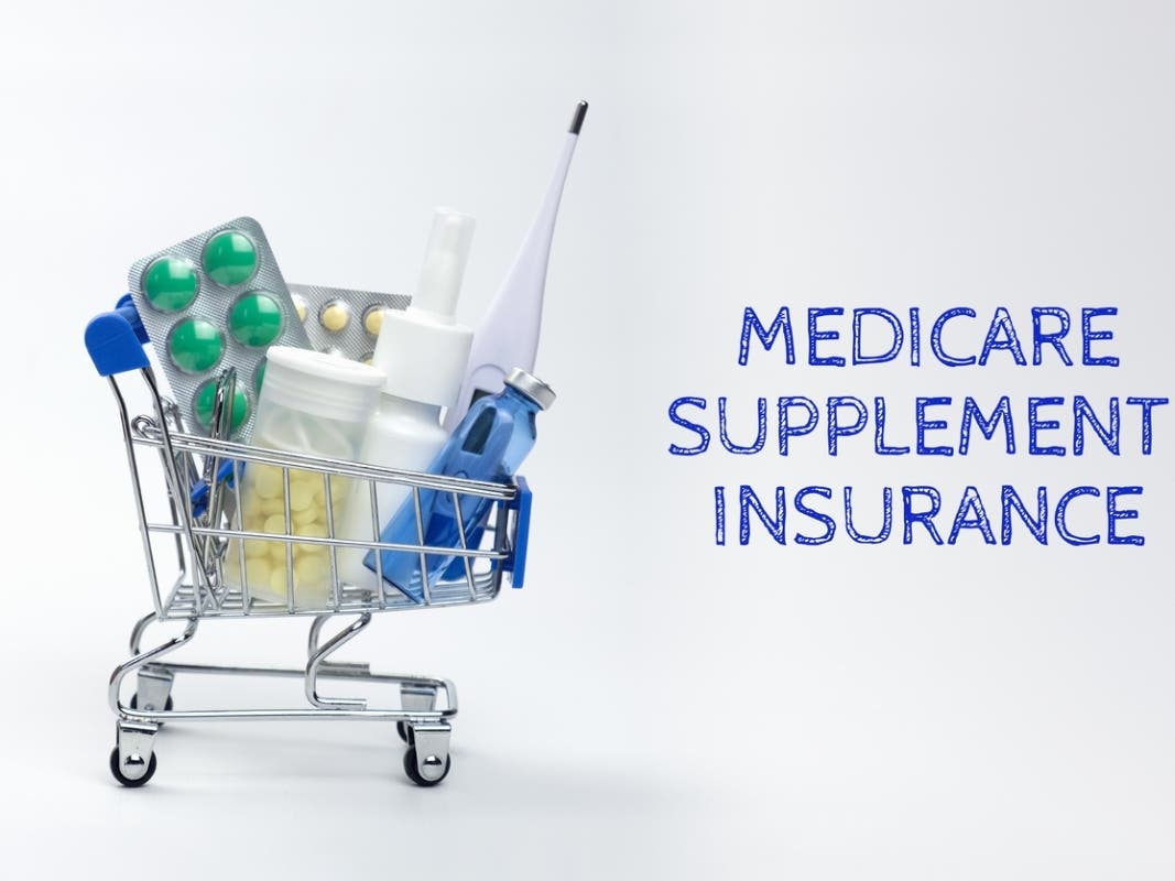 full of medicines little shopping cart and the inscription Medicare supplement insurance