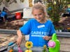 Blakely Morrison from Wheaton Bible Church plants flowers at the DuPage PADS Homeless shelter in Downers Grove. 