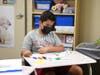Fifth-grader Kierat Jolly, of Greenwich, designs his name tag on the first day of school. 