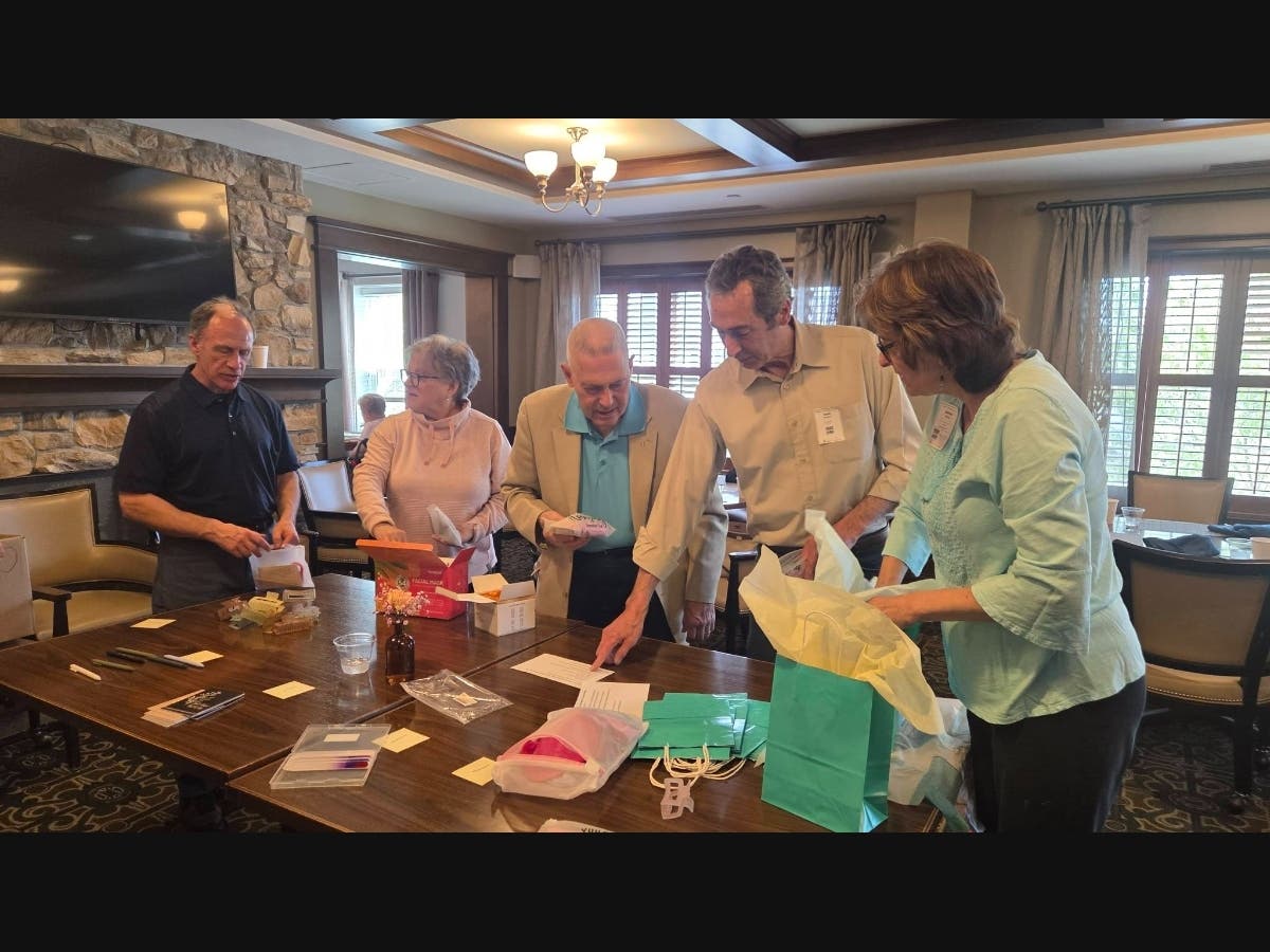 Rotarians Jim Fitzgerald, Lisa Roderick, Rick Krempin, Gene Mullen and Barbara Worley set up the station to make the "treat" kits for Centerboard.