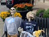A skeleton family sponsored by the Jasinski Home Team sits on a bench.