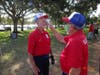 Lou Kalogeras checks Hal Olver's temperature before being authorized to enter field