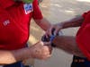Hal Olver passes COVID-19 temperature test and recieves blue ban authorizing his entry to the field