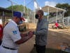 Ed Broomes places ID strip on the wrist of Erik Mathre, Club photograph and website manager