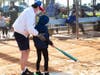 A preliminary game scheduled at 9:00 AM, Kids & Kubs vs. TASCO Teens, will bring an enthusiastic squad of younger men and women to oppose the Grandfathers of the game. In this picture Ed Asay, Board Member assist young Pre-teen with a t.me at bat .