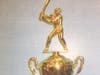 This Gold figure sets on top of the traveling trophy exchanged annually between the Mayor's office and the Kids and Kubs (Sunshine Senior Center)  office at 330 5th St. N., St Petersburg. City Hall Stars won in 2022, 13-6.