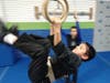 Academy student flipping on the rings