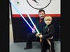 Owner of the Academy Joel Waldron and the littlest Jedi Carl Johnson show off their light sabers at the Academy in Manchester.