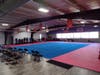 Of of the Academy training rooms including rings, ropes, rope ladder, rock climbing wall, boxing bags, light weights, small and large pads, vaulting boxes, and more!
