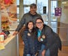 Amarillys Vazquez takes a picture with student Andrea Flores and her father Carlos Flores