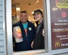 Teacher Victor Baez works the drive-thru with McDonald's staff member Joseph Gorman