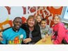 Happy faces from St. Raymond Third Graders Kylie and Brianna Favia along with Karen Maycan and Father Gilbert at the McT