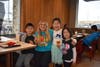 Lakeview teacher Allie Issleib greets Shintaro, Haruka, and Mari Iida