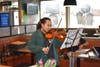 Student Alika Shelton plays the violin for diners