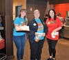Teachers Linnemann,Toronyl, and Smith selling cookies at McTeacher's Night