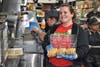 Teacher Gomaz bakes cookies to sell at McTeacher's Night