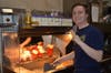 Stephen Claybaker works hard at fries to support the Girl Scout Fundraiser organized by his sister Elizabeth.