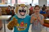 Fiona Wickman gets a picture with Bommer the Bobcat at McTeacher's Night.