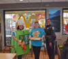 Officer Calice take a picture with McPie teacher Fuller and pie seller Gough during the FUNraiser for Washington Middle 