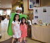 Students Fiona and Violeta Sanchez are excited to see Teacher Beth Karcz dressed as an Apple Pie at McTeacher's Night