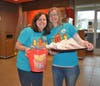 Kendall Troyke and Michelle Ludwig are cookie selling queens at McTeacher's night for Trinity Lutheran School.​