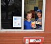 Colin Tamillo and Noah Ballantyne​​ collect donations at the drive- thru​