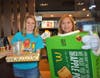 Kristin Green​ helps sell pies alongside Marsha Stierwalt in an Apple Pie costume to raise money for the AGS School