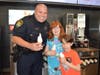 Grace and Tyler Rowland get cones from Officer Creighton.